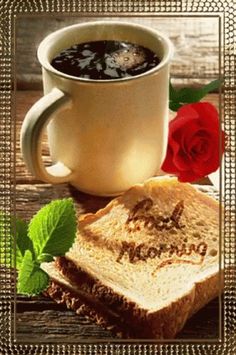 a cup of coffee and some bread on a table