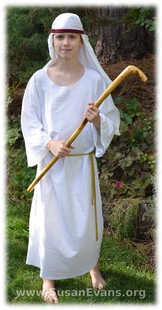 a man dressed as jesus holding a stick