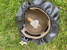 an overhead view of a metal object in the grass