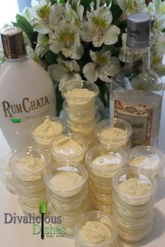 a table topped with lots of white flowers next to bottles and containers filled with liquid