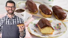 a man holding a pastry in front of some desserts