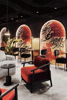 a room filled with lots of furniture and walls covered in graffiti