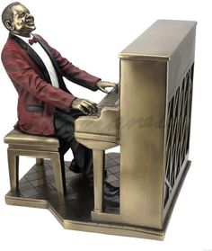 a statue of a man playing the piano