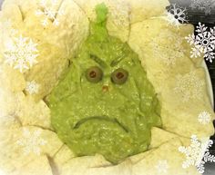 a green face in a tortilla shell with snowflakes around it's edges