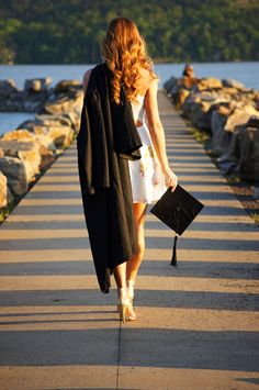 a woman is walking down the street with her purse