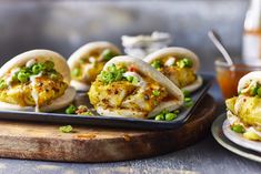 some food is sitting on a plate and ready to be eaten with sauces in the background