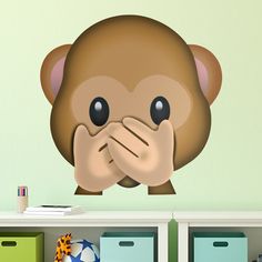 a sticker with a monkey covering its mouth and hand over it's face