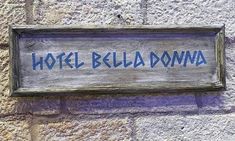 a sign on the side of a building that says hotel belda downa in blue ink