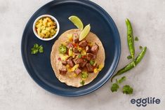 a taco on a plate next to a bowl of salsa