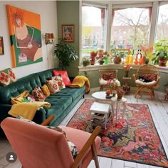 a living room filled with lots of furniture and colorful pillows on top of it's couches