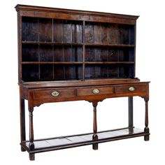 an old wooden bookcase with two drawers and one shelf on the bottom, against a white background