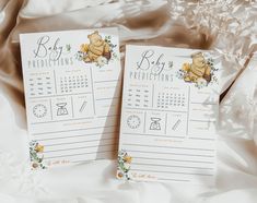 two baby shower calendars with winnie the pooh on them sitting next to each other