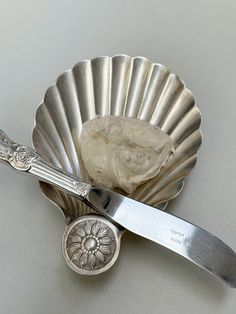 a spoon and knife sitting on top of a silver plate