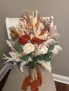 a bouquet of flowers sitting on top of a white chair