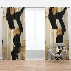 a chair sitting in front of a window covered in black and gold curtains with an abstract design