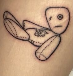 a small tattoo of a teddy bear on the thigh