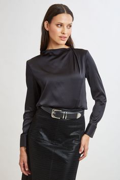 Chic & edgy, the draped neck of our luxe Silk Satin shirt creates a cool modern vibe that feels as good as it looks. The luxe patina, relaxed fit & soft neckline lend a feminine vibe to this must-have silk shirt. Elie Tahari Exclusive Long Sleeve Draped Neck Silk Shirt 93% Silk, 7% Elastane Runs true to Size Length From Shoulder to Hem: Back 23.25"L, Sleeve: 32.5"L (approx. length for size S) Model is 5'9" and wearing size XS Dry Clean Only Imported Style #: E9053534 Modern Long Sleeve Top For Evening, Modern Long Sleeve Evening Top, Modern Tops For Night Out, Sleek Blouse For Night Out, Sleek Office Tops For Fall, Sleek Fall Office Tops, Modern Tops For Night Out In Fall, Sleek Fall Blouse For Date Night, Sleek Formal Tops For Fall