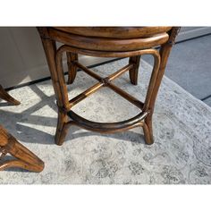 two wooden stools sitting next to each other on a carpeted floor in front of a door