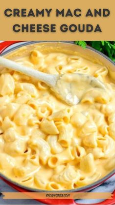 creamy macaroni and cheese goulash in a red bowl with a wooden spoon