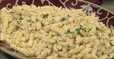 a plate full of macaroni and cheese with parsley