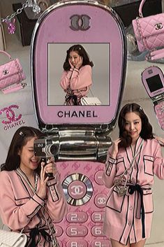 two women in pink outfits are taking pictures with their cell phones and purses while standing next to each other