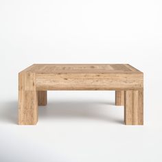 a wooden coffee table sitting on top of a white floor