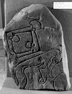 an ancient stone carving on display in a museum