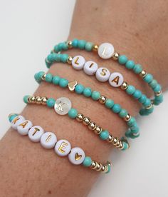 "Beautiful custom name bracelets with blue howlite and your choice of either 18k gold plated beads or 14k gold filled beads...these stretchy gold bead bracelets would make perfect bridesmaids gifts, birthday gifts, best friend gifts, or a special gift just for you. Comfortable, elegant, and affordable bracelets for your easy care lifestyle. Please select your variation when ordering....add items one at a time to your cart. A. Mother of pearl initial bracelet with blue howlite and gold bead accen Personalized Turquoise Beaded Bracelets, Bead Name Bracelets, Birthday Gifts Best Friend, Bracelets Preppy, Baseball Bracelet, Gifts Best Friend, Mama Bracelet, Preppy Bracelets, Name Bracelets