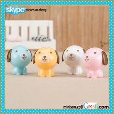 three small plastic dogs sitting next to each other