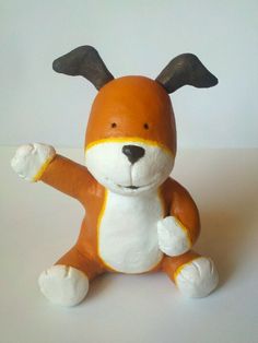 an orange and white stuffed animal sitting on top of a table