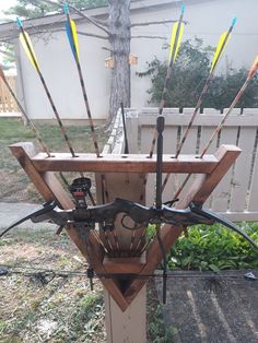 an outdoor archery target set up in the yard with arrows stuck to it's back