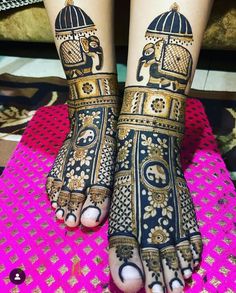 the feet and hands of a woman with henna tattoos on them, both decorated in gold