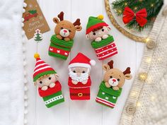 knitted christmas ornaments are arranged on a table