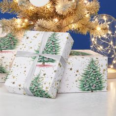 three wrapped presents under a decorated christmas tree