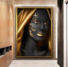 a woman's face painted with gold and black on a wall in a bathroom