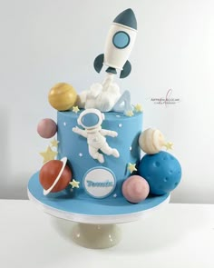 a birthday cake with an astronaut on top