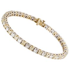 18K two-tone gold straightline bracelet with yellow and white diamonds. There are 26 cushion-cut yellow diamonds, set in yellow gold, that total 5.75 carats; fancy intense yellow color and VS-SI clarity. Also, there are 24 radiant-cut diamonds totaling 4.25 carats; G-I color and VS-SI clarity. Total diamond carat weight is 10 carats. Bracelet measures 7 1/2 inches long and 1/8 inches wide. Tongue closure with underneath safety. Classic Yellow Jewelry With Single Cut Diamonds, Formal Yellow Diamond Bracelet, Elegant Yellow Diamond Bracelet For Formal Occasions, Formal Yellow Jewelry With Single Cut Diamonds, Luxury Yellow Bracelets For Anniversary, Fine Jewelry Yellow Bracelets For Anniversary, Classic Yellow Jewelry With Jubilee Bracelet, Yellow Fine Jewelry Bracelets For Anniversary, Bracelet Tennis