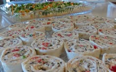 several rolls are arranged on a glass platter and ready to be served at a party