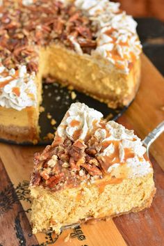 a piece of cake with pecans and whipped cream on top sitting on a cutting board