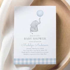 a baby shower card with an elephant holding a blue ballon on it's back