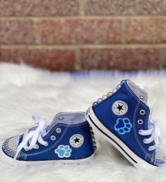 pair of blue shoes with paw prints on them