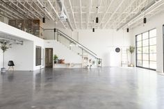 an empty room with white walls and metal railings on the second floor is shown