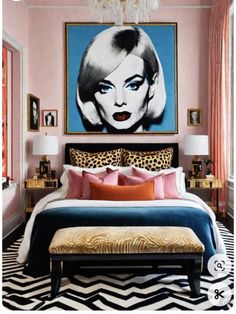 a bedroom with pink walls and black and white cheetah print on the wall