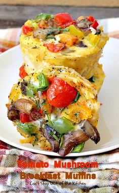 an omelet with tomatoes, mushrooms and other vegetables is on a white plate