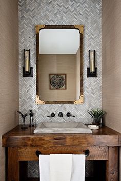 a bathroom with a wooden vanity and mirror