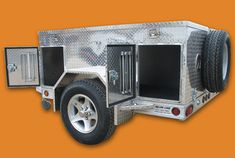 an aluminum trailer with two doors on the side and one door open to allow additional storage space