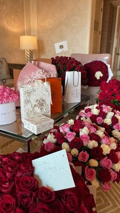 roses and other flowers are on display in a hotel lobby with gifts for the bride