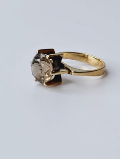 Introducing this gorgeous 14 karat gold ring with a stunning gemstone, a true representation of exceptional Mid-Century jewelry. This ring is not only a perfect gift for your wife on her birthday, but it also serves as a jewelry gift that holds sentimental value. It makes an equally amazing Granny gift or a remarkable statement ring for anyone who appreciates vintage pieces. Crafted with love, this lovely ring showcases real 14 carat gold that dates back to the 1950-1960s. Although it exhibits age-related wear on both the stone and the ring itself, it remains in fine vintage condition. This timeless piece is an ideal choice for those passionate collectors of vintage jewelry or for anyone who seeks to present a finer, more unique gift. It proudly bears both a 585 gold stamp and a master sta Luxury 14k Gold Diamond Ring With Gemstones, Luxury 14k Gold Topaz Wedding Ring, Elegant 14k Gold Topaz Ring With Prong Setting, Timeless Ethical Wedding Ring, Elegant Jewelry With Rose Cut Round Diamonds, Timeless 14k Gold Brilliant Cut Topaz Ring, Luxury Yellow Gold Topaz Ring With Rose Cut Diamonds, Formal Diamond Ring With Rose Cut Round Stone, Formal Rose Cut Diamond Open Ring Jewelry