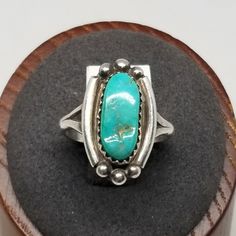 Vintage BG Sterling with Turquoise Ring, Size 7. Marked Sterling BG inside band. Stone is 14 x 6mm. Ring is 20mm wide. Weighs 0.13 ozt. We do not check prongs for wear or stones for looseness. All items are sold AS IS, noting that we are a resale shop so everything here had a previous owner! We will include flaws in the description when noted. This is one of the reasons our items are more affordable than new at a jewelry store. Are these stones real or fake? Aside from diamonds, we do not know if any gemstones are natural or synthetic. We will state on certain gemstones, that we know 100%, if they are created or fake due to their lack of inclusions. For this reason, we do not sell any diamonds without inclusions, and the larger diamonds (half ct+) are soft graded. In recent years, syntheti Classic Turquoise Ring For Collectors, Classic Turquoise Rings Collectible, Classic Turquoise Rings For Anniversary, Classic Turquoise Ring As Gift, Classic Collectible Round Turquoise Ring, Classic Adjustable Turquoise Ring Gift, Classic Adjustable Turquoise Ring As Gift, Untreated Adjustable Oval Turquoise Ring, Classic Turquoise Ring Stamped 925