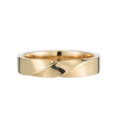 a yellow gold wedding ring with wavy edges on the outside and inside, set against a white background